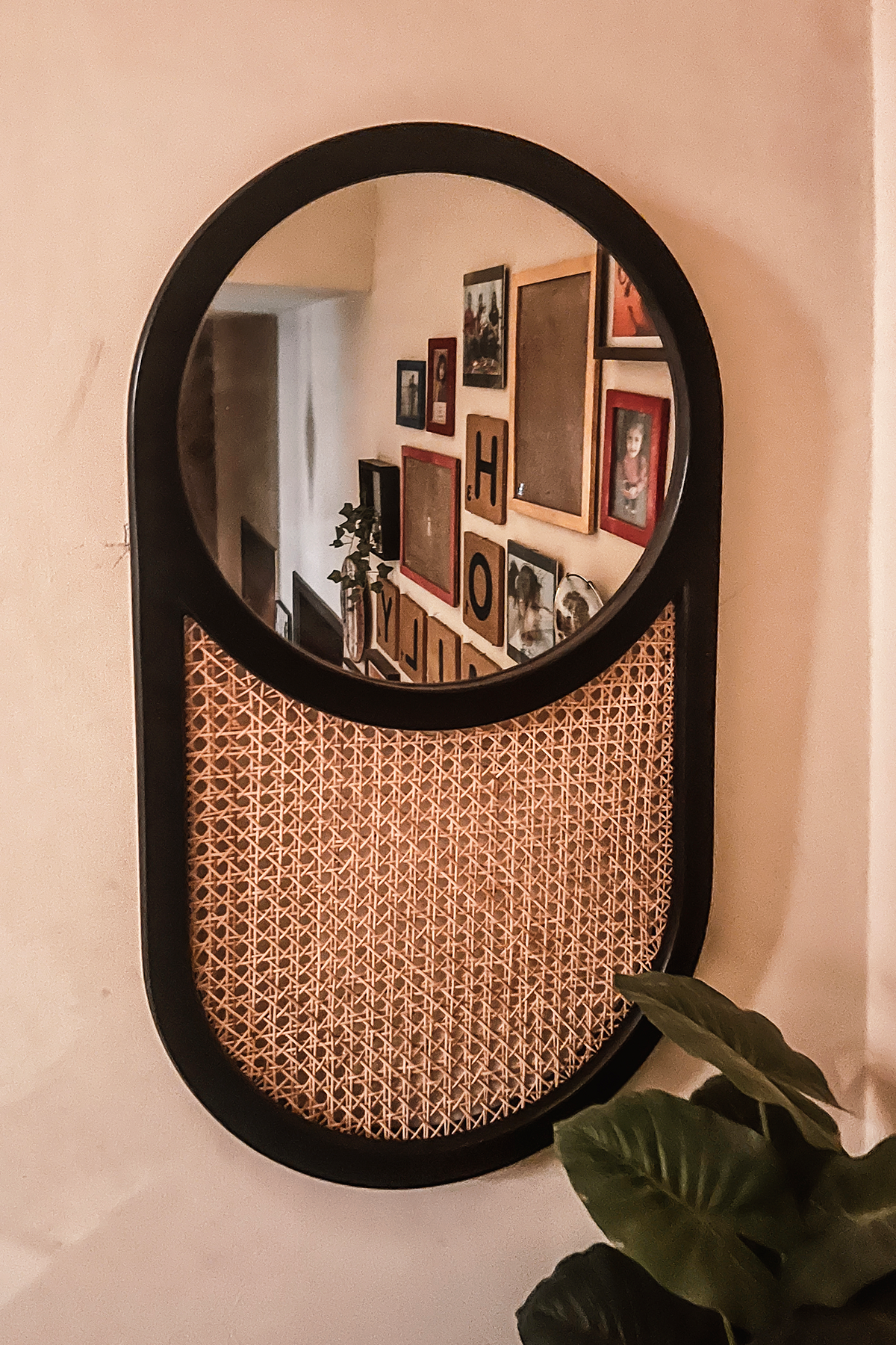 Oval black rattan and wood mirror